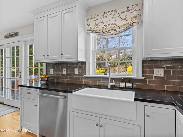 a kitchen with a sink cabinets and window