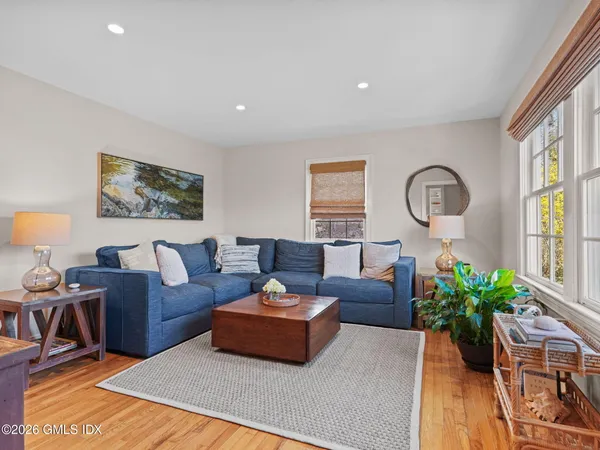 a living room with furniture potted plant and a large window