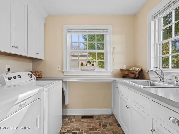 a utility room with sink dryer and washer