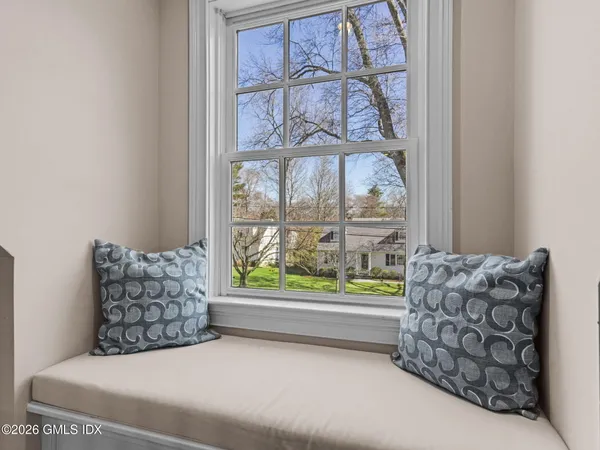 a bedroom with furniture and a large window