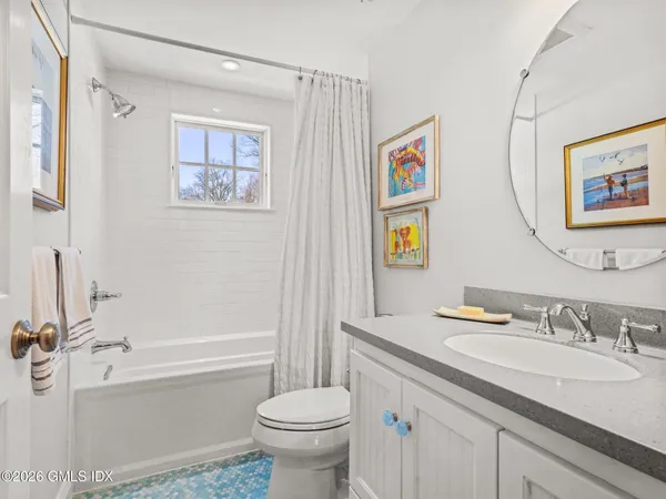 a bath room with a toilet a sink and a bath tub