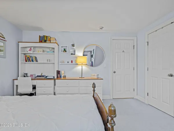 a room with a bed and a dresser