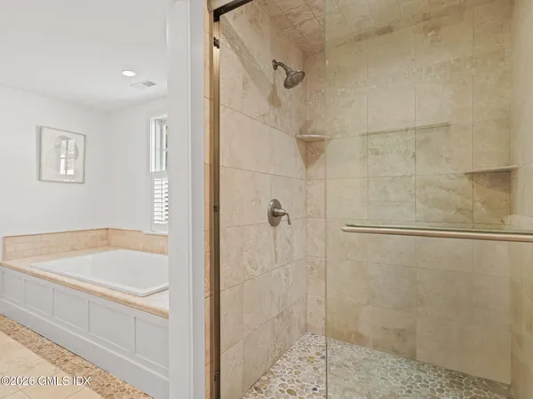 a bathroom with a shower and a bath tub