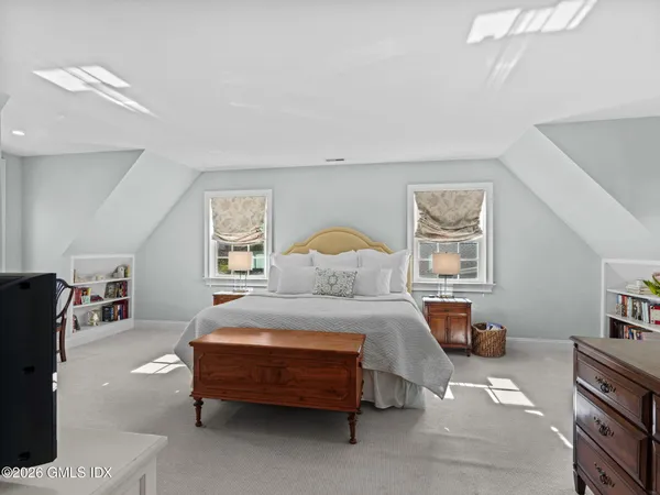 a bedroom with a bed and dresser in it