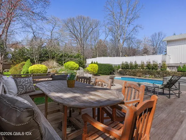 a view of a patio with furniture and a yard