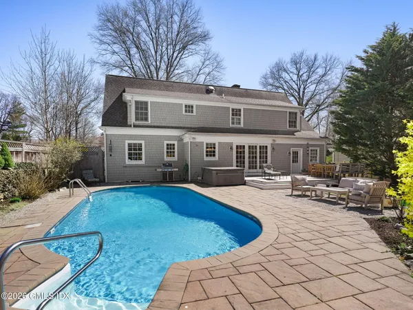 a view of a house with swimming pool and sitting area