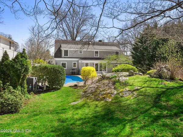 a house view with a sitting space and garden