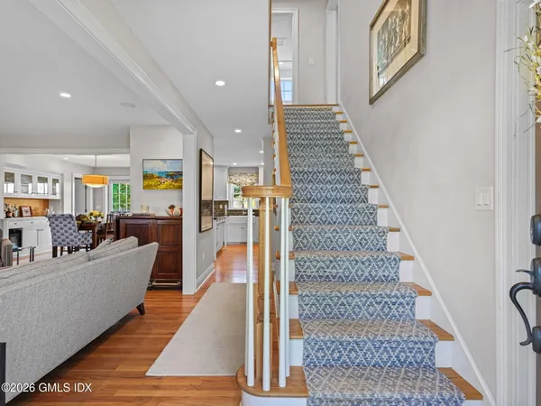 a view of entryway and hall with wooden floor