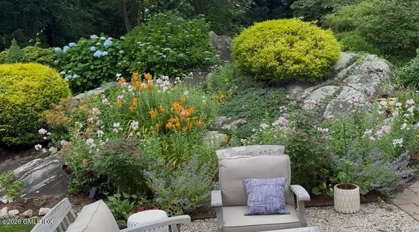 a view of a backyard with chair and table