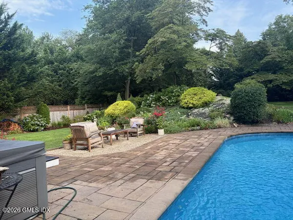 a view of a backyard with sitting area furniture and garden