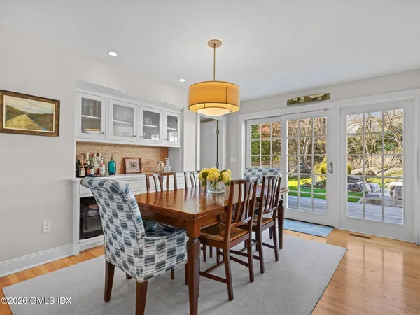 a dining room with furniture a chandelier and wooden floor