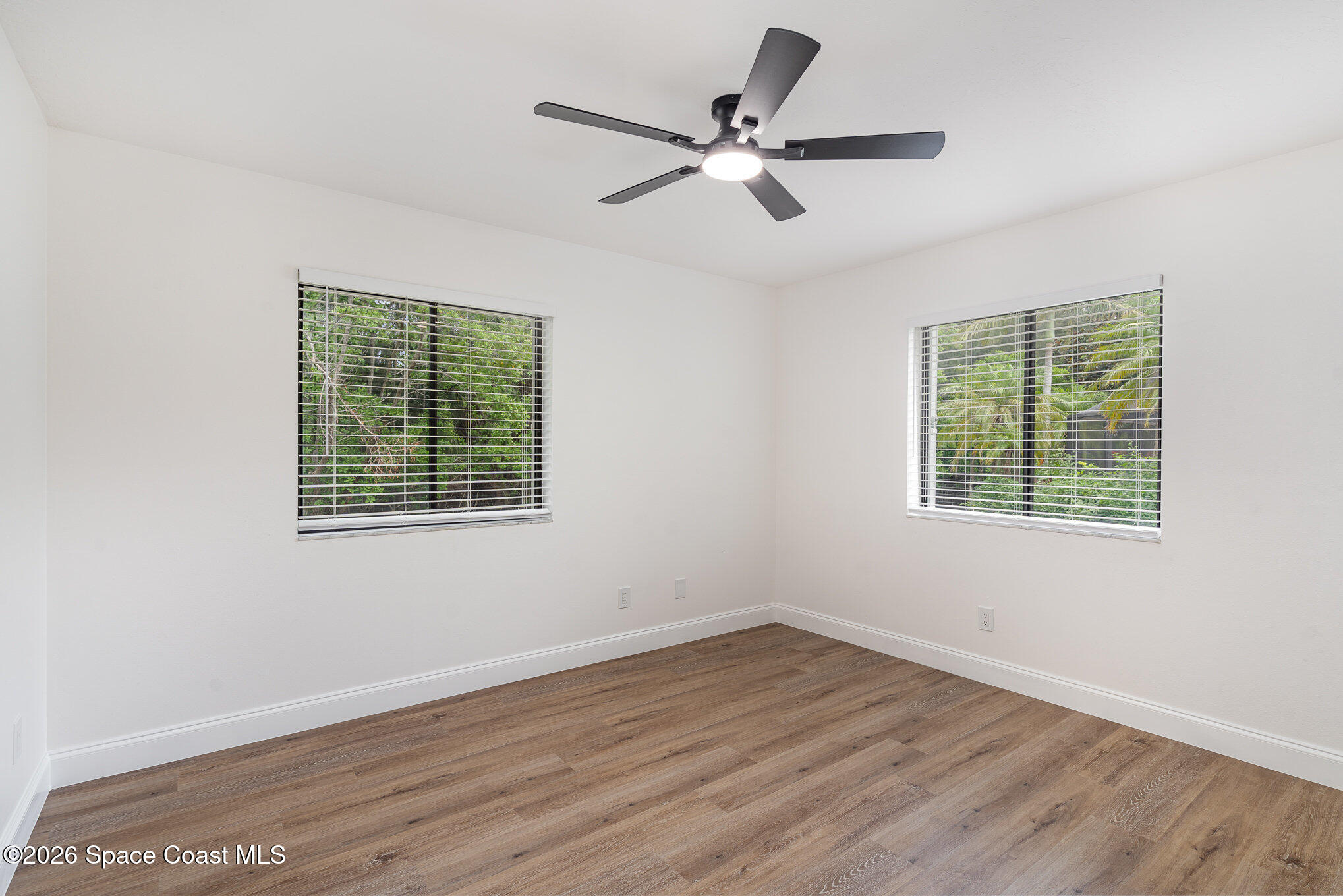 362 Nikomas Way Melbourne Beach, FL 32951 - Photo 15 of 32 wooden floor in an empty room with a window