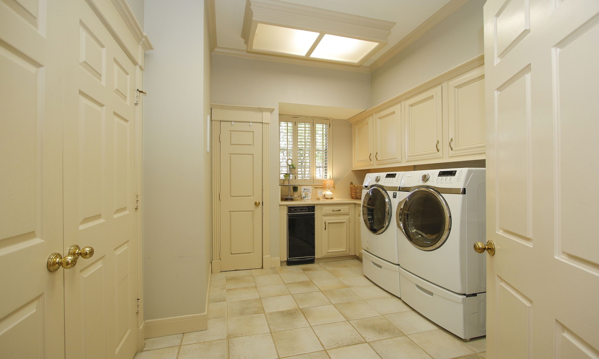 15923 Harwick Drive Spring, TX 77379 - Photo 29 of 50 Who says laundry rooms can't be impressive? This oversized utility room features abundant cabinetry, workspace for projects, a sink (behind the door), trash compactor and a massive second pantry that keeps everything neatly tucked away.