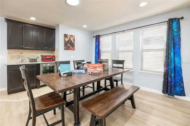a living room with furniture flat screen tv and wall paintings