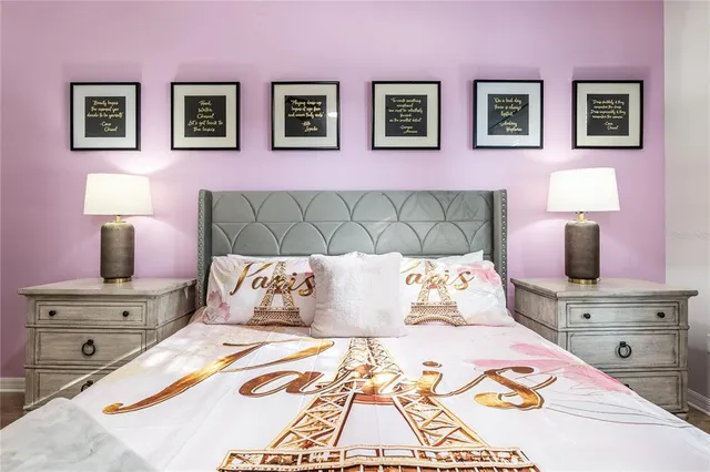 a bed sitting in a bedroom next to a window