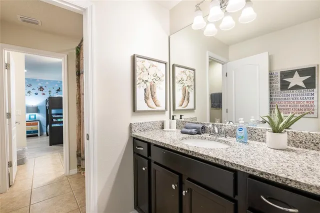 a front view of a house with a garden and tree