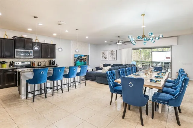 a view of a dining room with furniture a chandelier and wooden floor