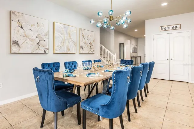 a living room with furniture a dining table and a flat screen tv