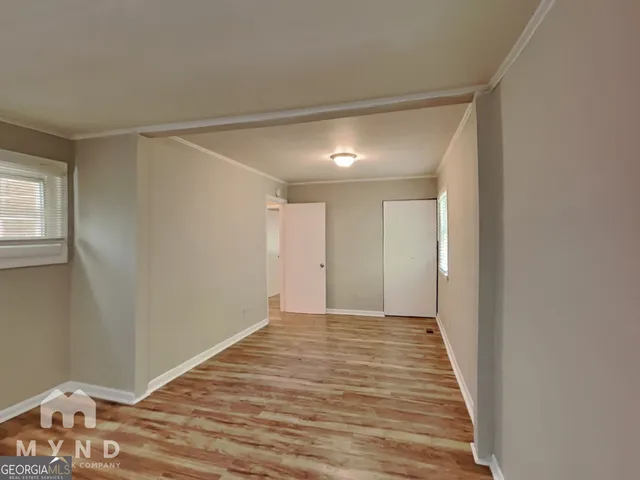 a view of a room with wooden floor