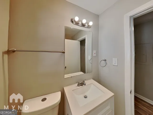 a bathroom with a sink a toilet and mirror