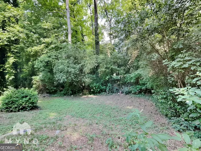 a view of a green field with lots of bushes