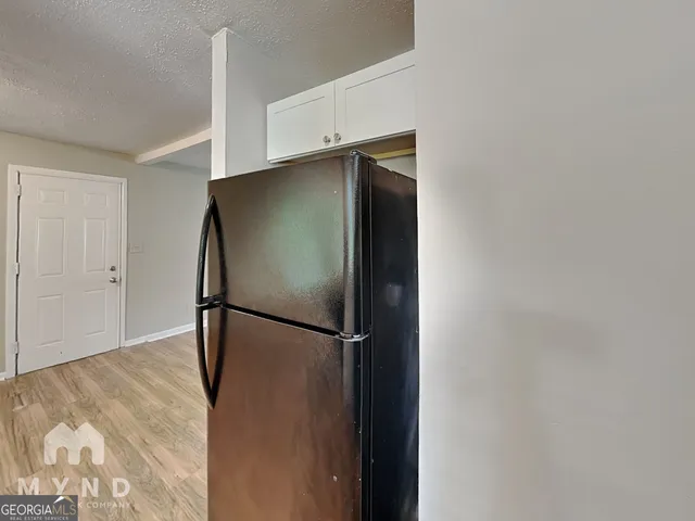 a view of a refrigerator in a kitchen