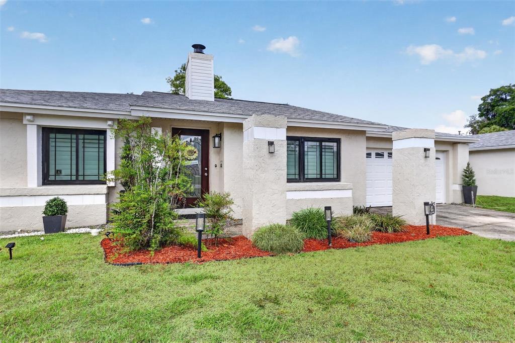 575 Tiberon Cove Road Longwood, FL 32750 - Photo 2 of 56 a front view of a house with a garden and plants