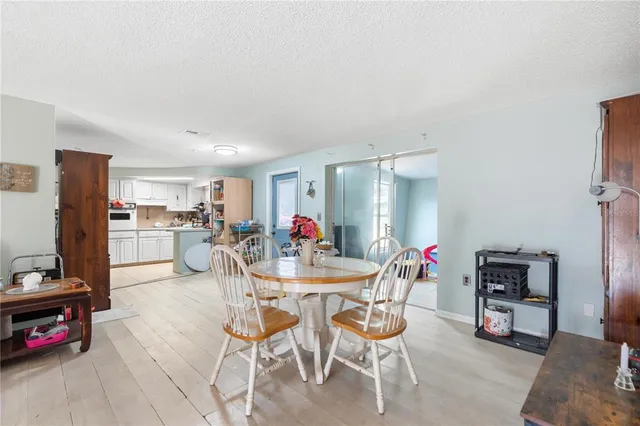 a dining room with furniture and a view of kitchen appliances