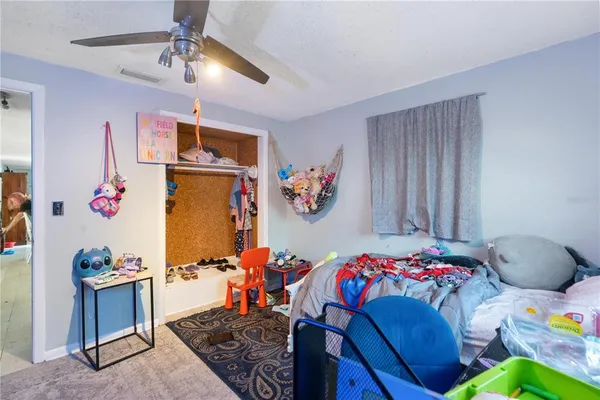 a bedroom with furniture and a window