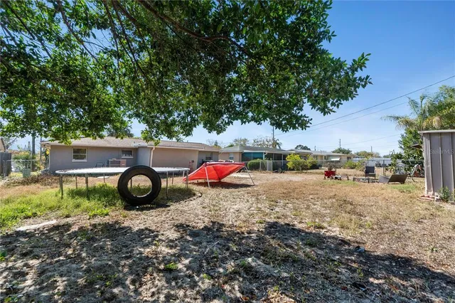 a view of a backyard with wooden fence