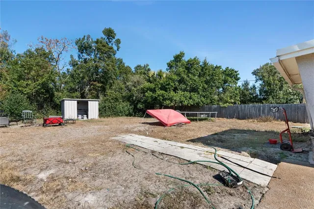 a backyard of a house with table and chairs