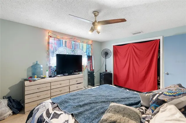 a bedroom with a bed and a flat screen tv