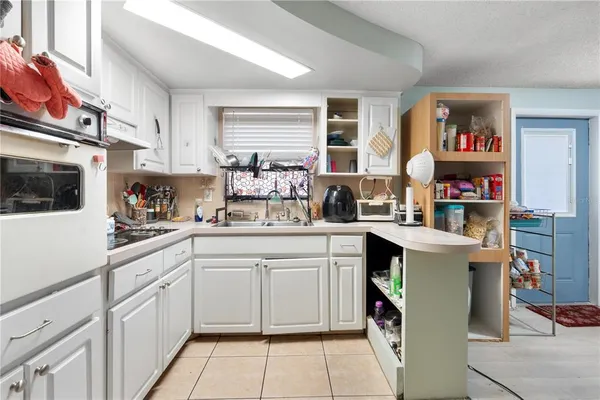 a kitchen with cabinets and window