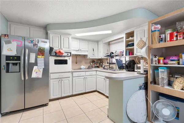 a kitchen with stainless steel appliances a stove a sink and a refrigerator
