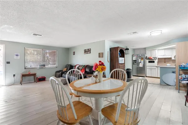 a dining room with furniture and wooden floor