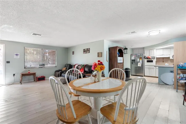 a dining room with furniture and wooden floor