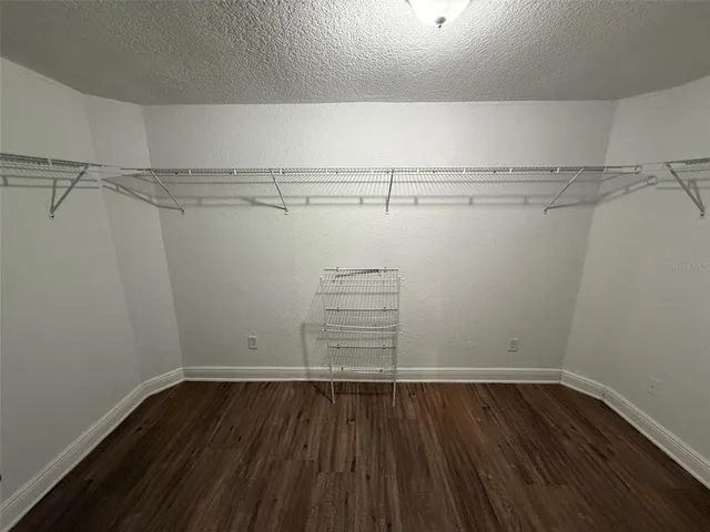 a view of walk in closet with empty racks