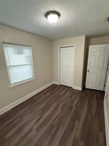 a bathroom with a granite countertop sink and a toilet