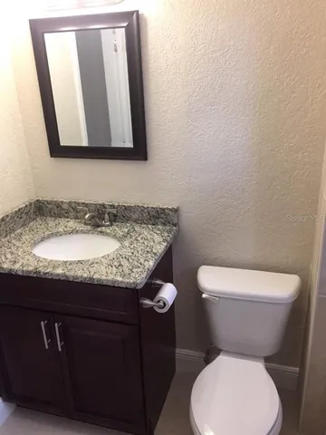 a bathroom with a white bath tub a toilet and a shower