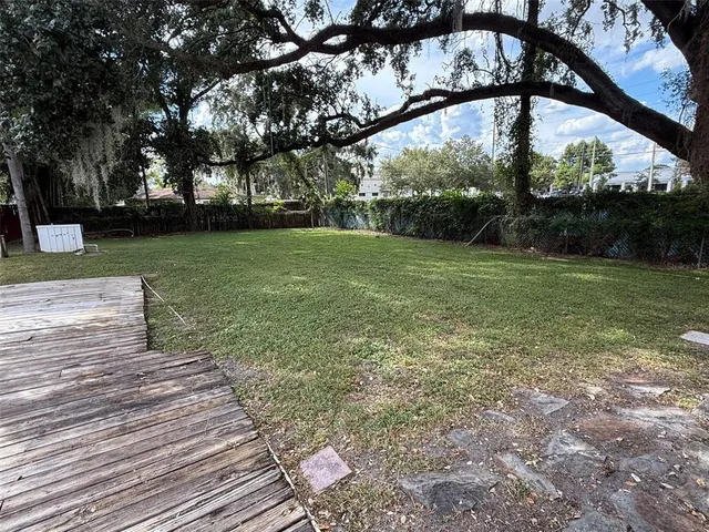 a view of a swimming pool with a yard