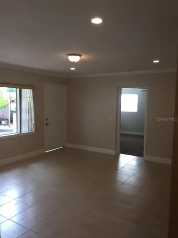 an empty room with windows and entrance