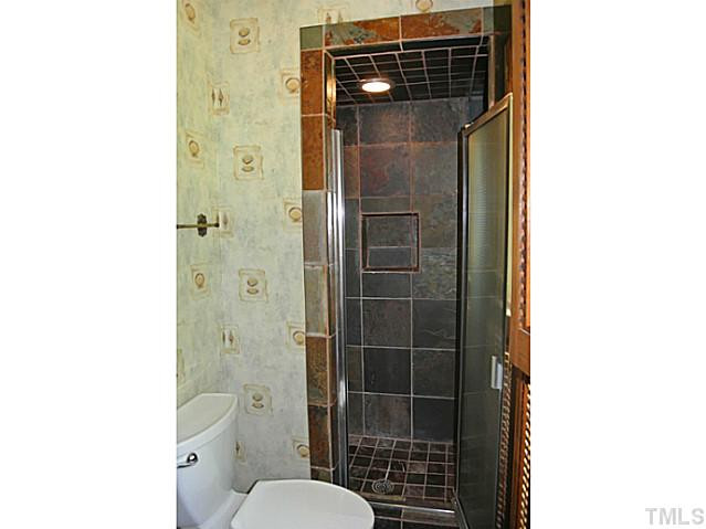 2215 Yorkgate Drive Raleigh, NC 27612 - Photo 23 of 24 The bathroom on the bonus/4th bedroom side of the house features a tiled walk-in shower with niche. Bathroom