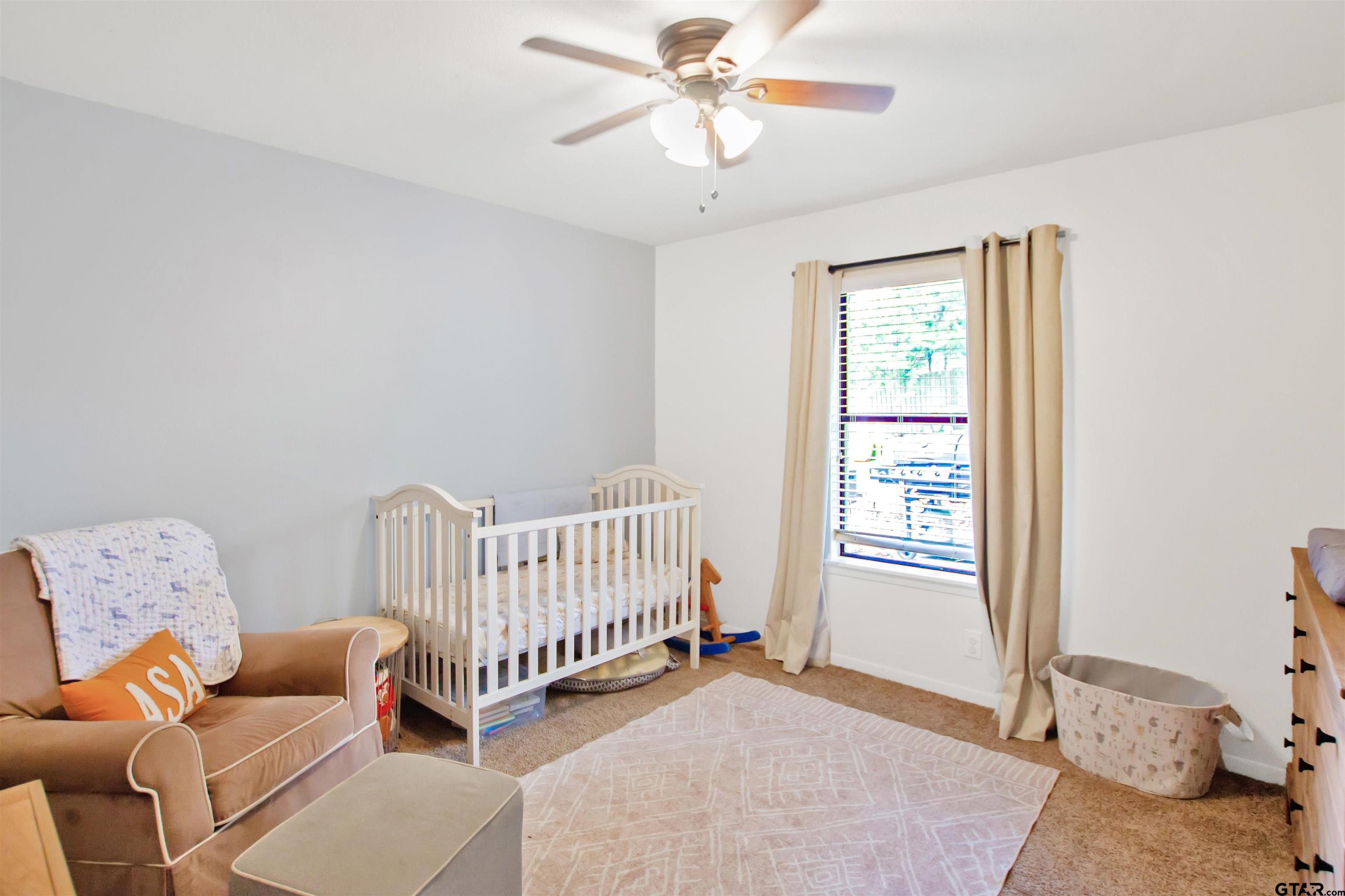 1908 Waunell Drive Tyler, TX 75701 - Photo 15 of 39 a bedroom with furniture and a window