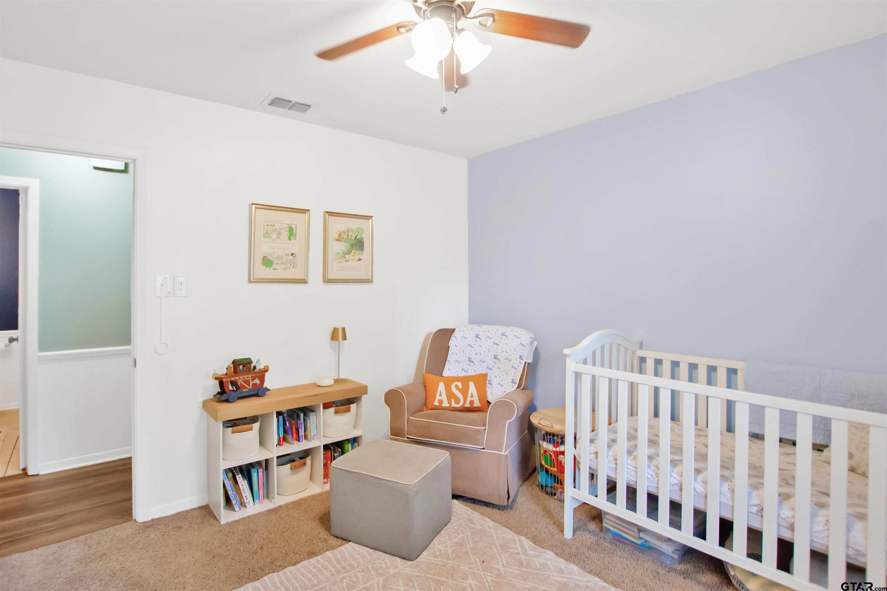 1908 Waunell Drive Tyler, TX 75701 - Photo 16 of 39 a bedroom with furniture and a book shelf