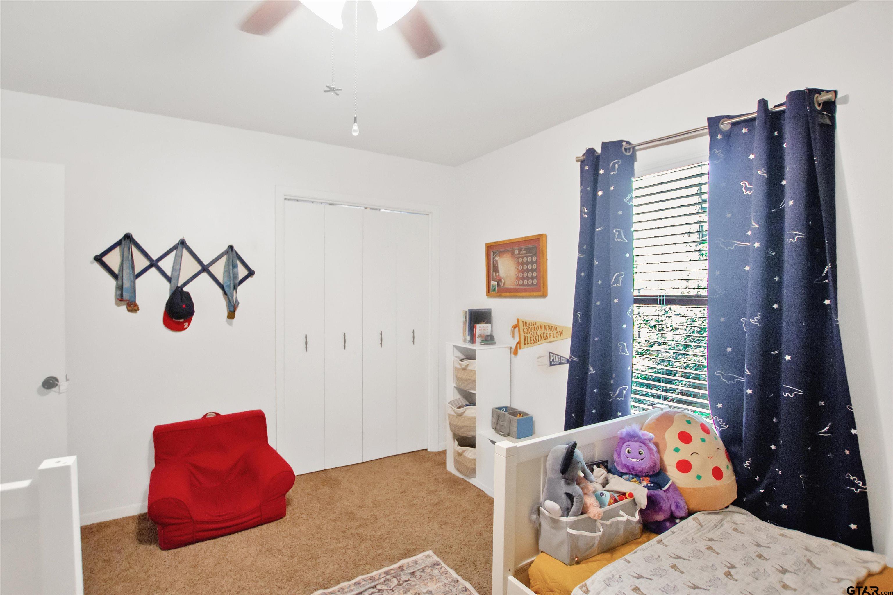 1908 Waunell Drive Tyler, TX 75701 - Photo 20 of 39 a bedroom with a bed and window