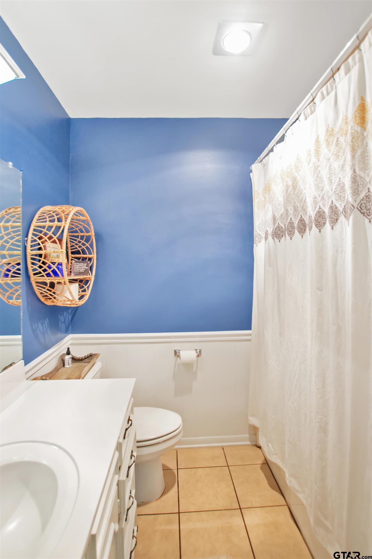 1908 Waunell Drive Tyler, TX 75701 - Photo 21 of 39 a bathroom with a sink a toilet and a shower curtain