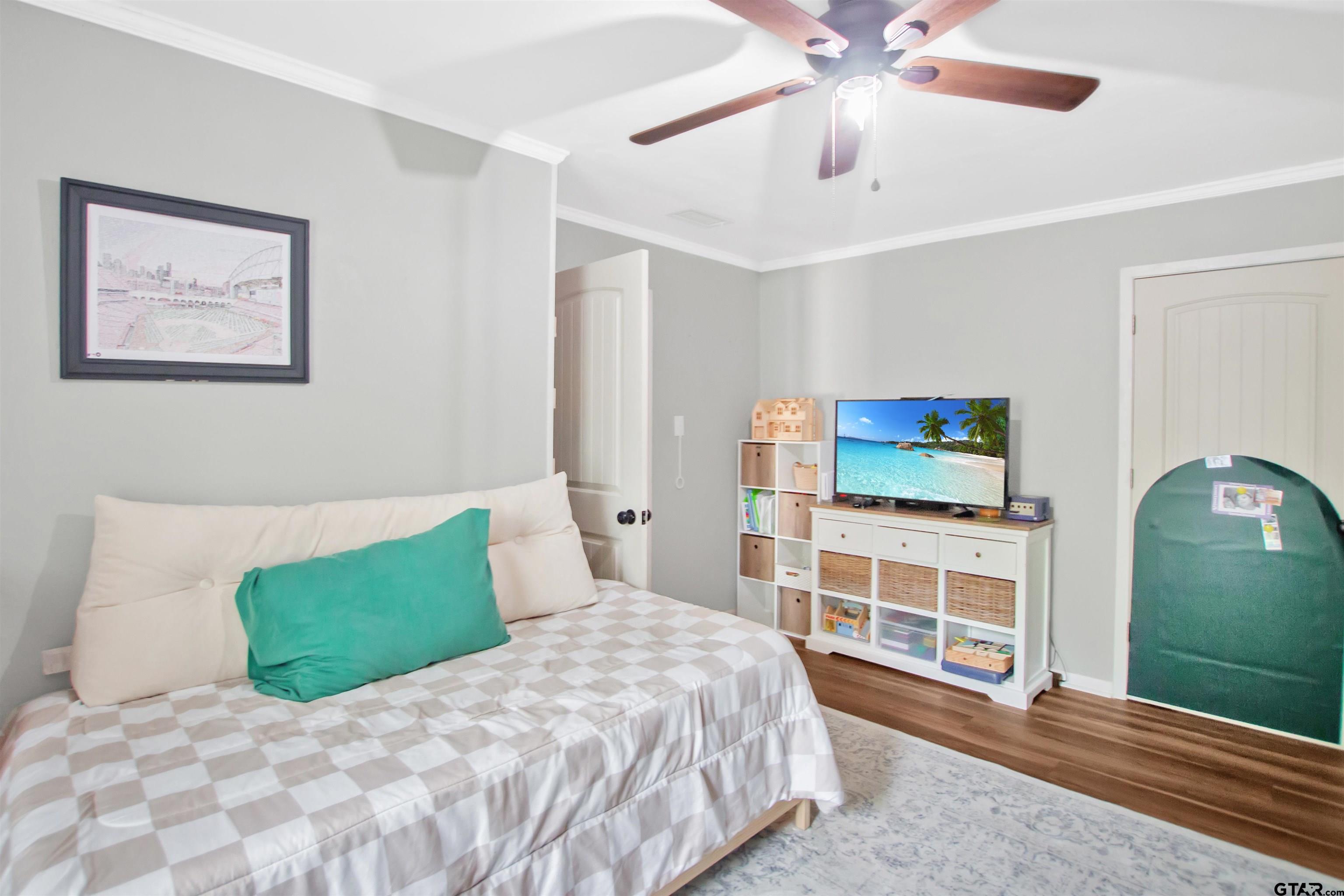 1908 Waunell Drive Tyler, TX 75701 - Photo 25 of 39 a bedroom with a bed and a flat screen tv