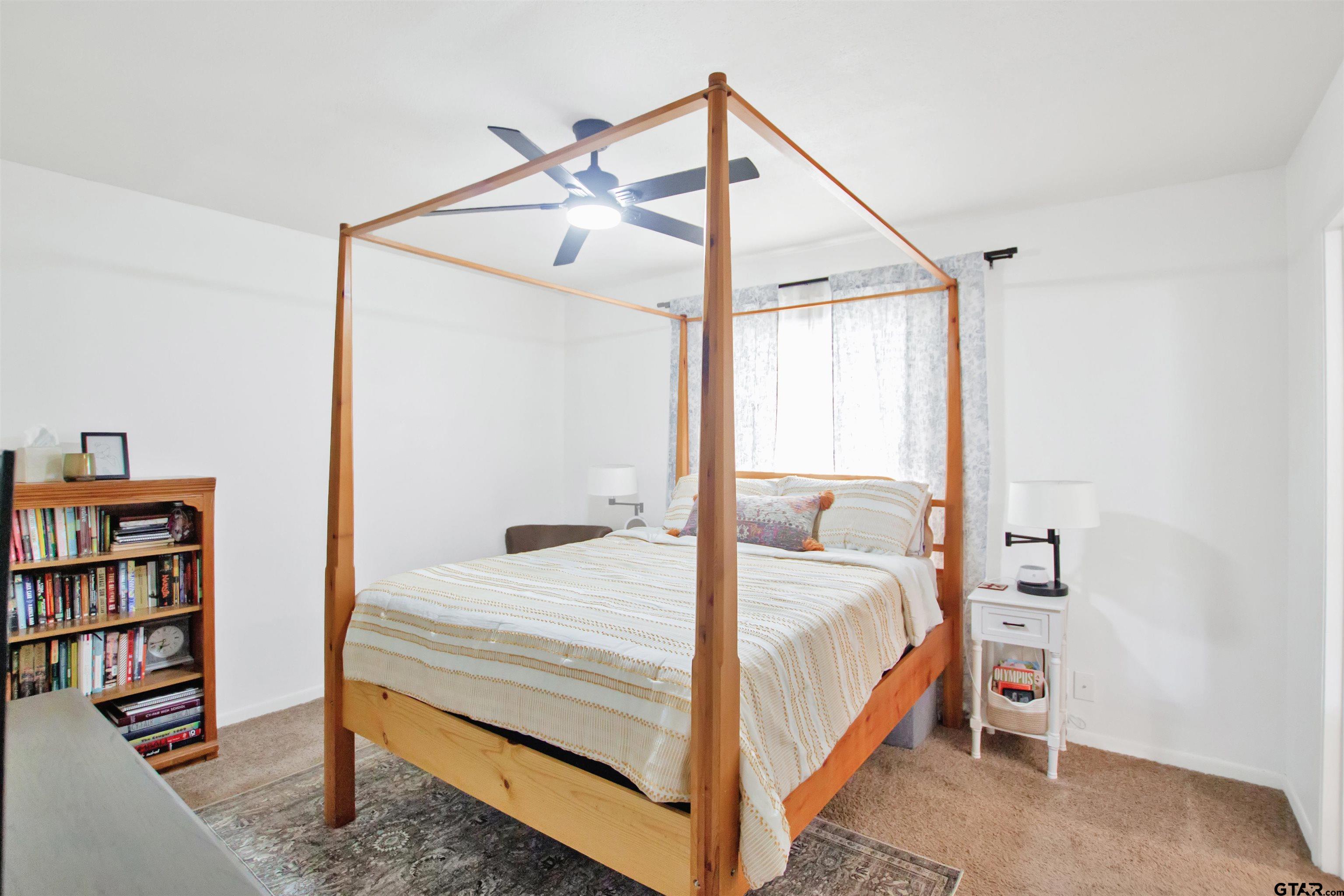 1908 Waunell Drive Tyler, TX 75701 - Photo 26 of 39 a bedroom with a bed and a book shelf
