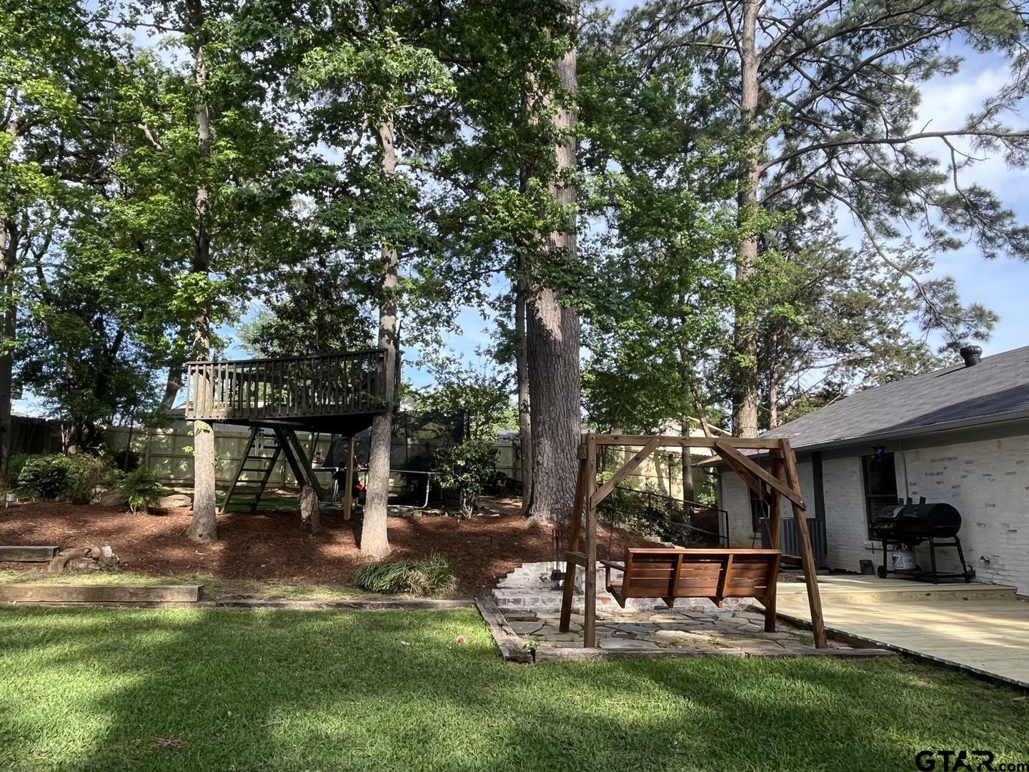1908 Waunell Drive Tyler, TX 75701 - Photo 32 of 39 a view of a park with bench and trees