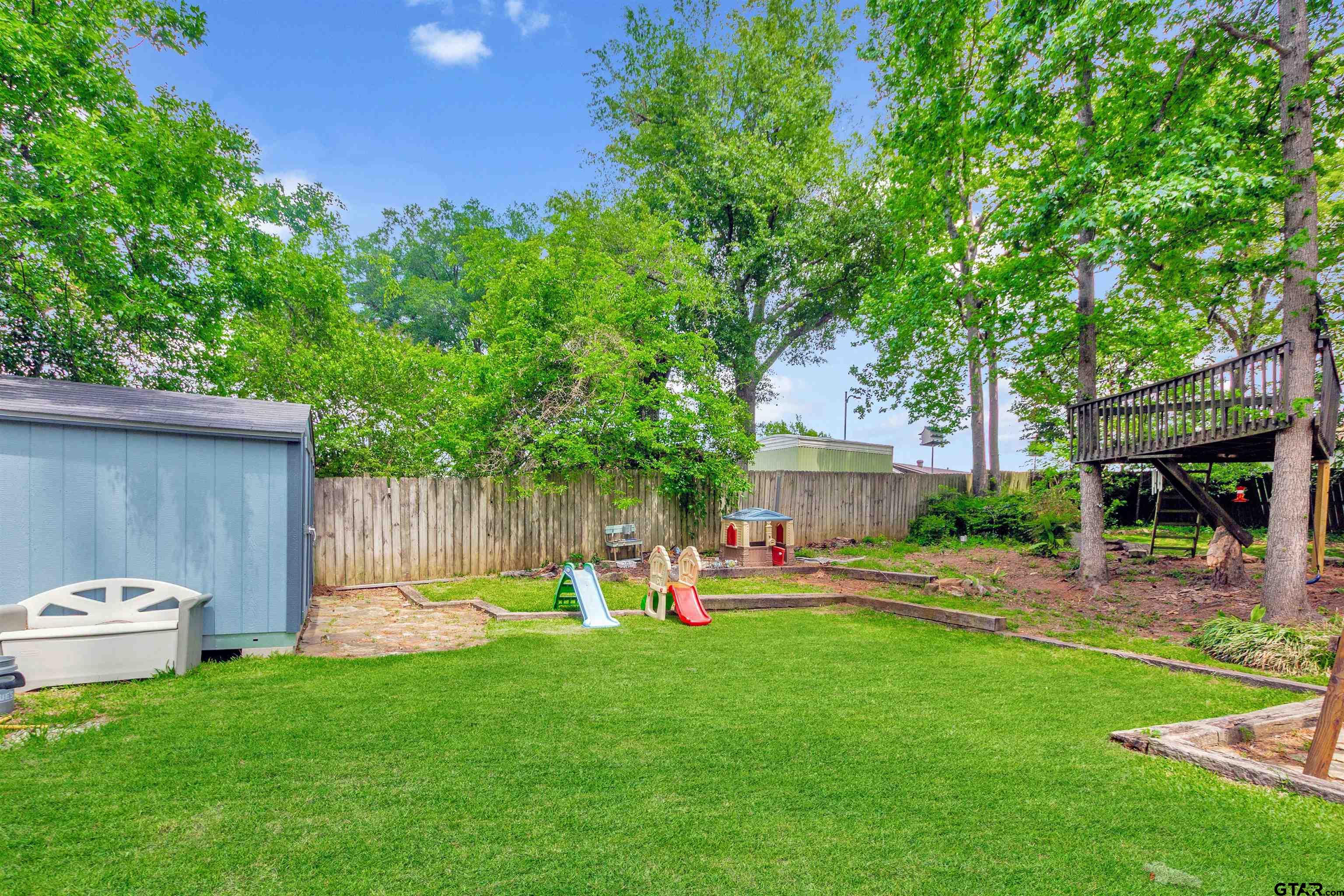 1908 Waunell Drive Tyler, TX 75701 - Photo 36 of 39 a backyard of a house with table and chairs